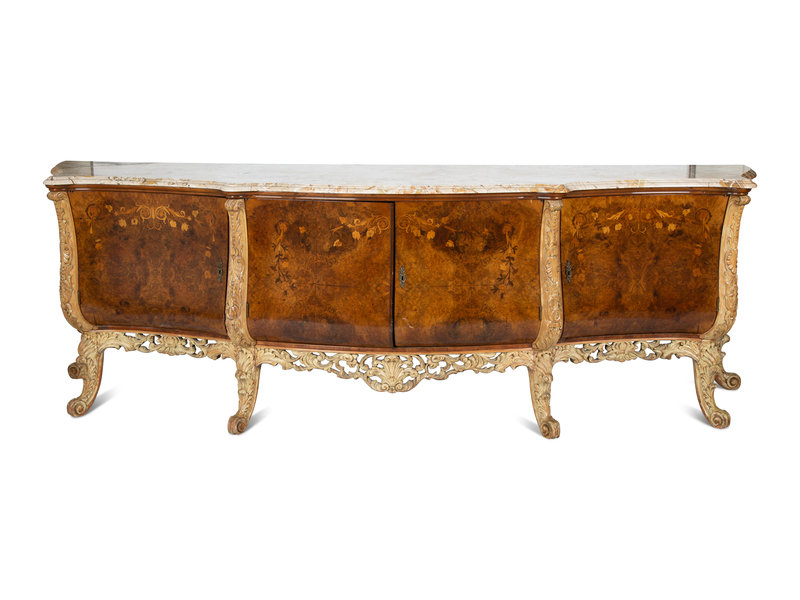 An Italian Carved Walnut and Marquetry Marble-Top Serving Cabinet
Height 38 x width 109 x depth 28 1/2 inches.