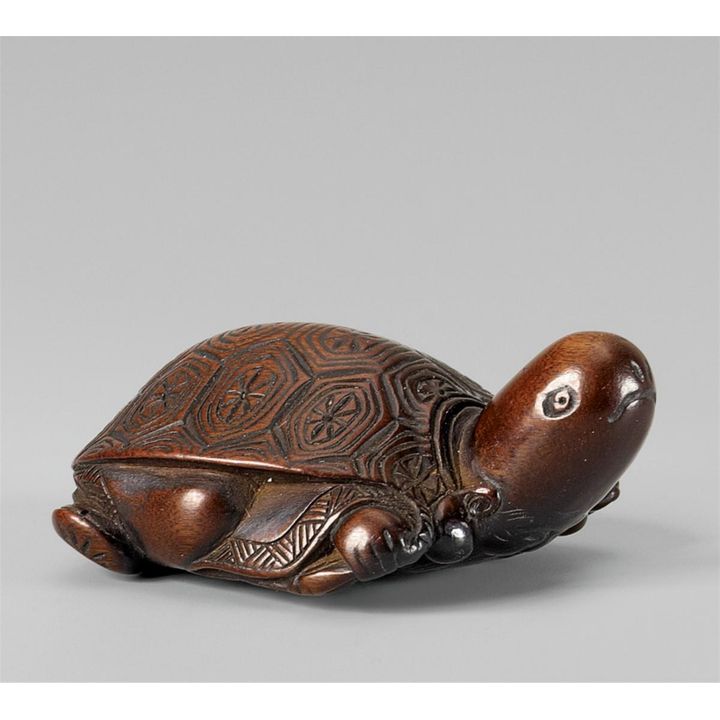 An amusing wood netsuke of Fukurokuju masquerading as a tortoise. Mid-19th century.