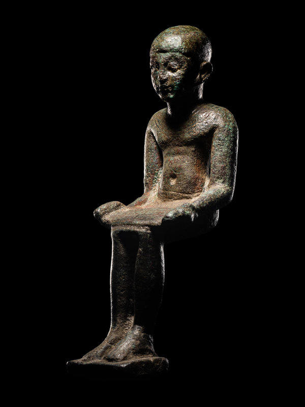 An Egyptian Bronze Imhotep with Silver Inlaid Eyes
Height 4 1/4 inches (11 cm).