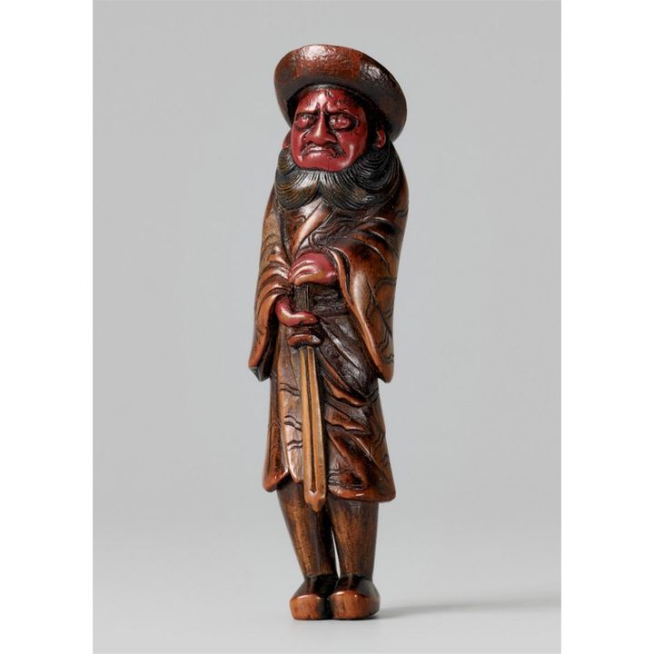 A lacquered wood netsuke of a tall Shoki. 19th century