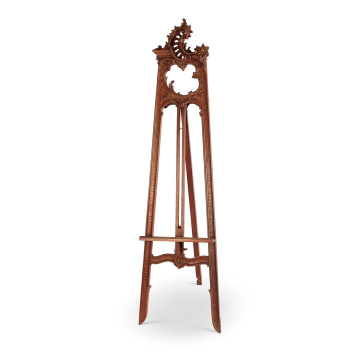A late 19th century carved walnut and parcel gilt standing folding easel