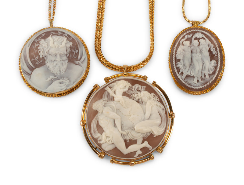 Three Italian Carved Cameos with Silver-Gilt Mounts
Height 3 inches. Length of longest chain closed 12 inches.