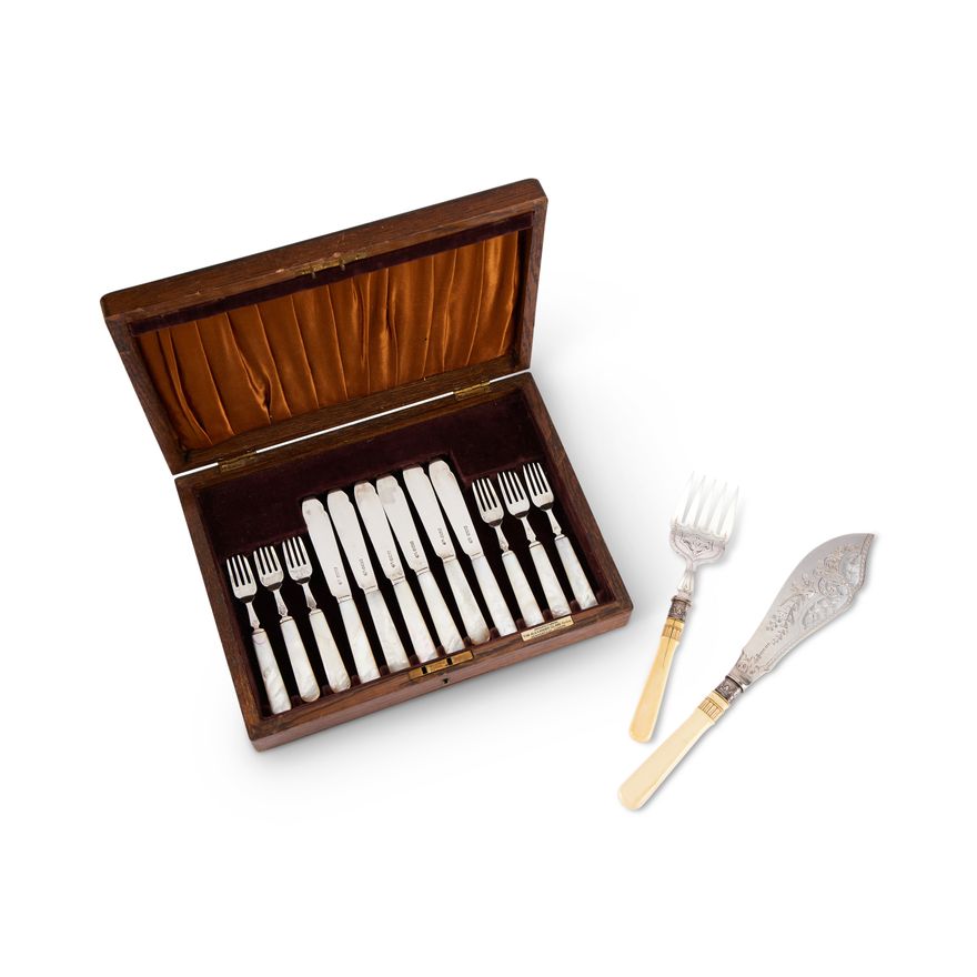 An oak cased set of six silver and mother of pearl handled fish knives and forks, and a pair of silv