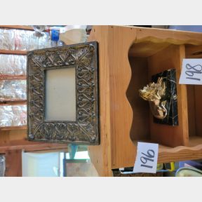 Photo frame and Lion licking the lamb on marble slab