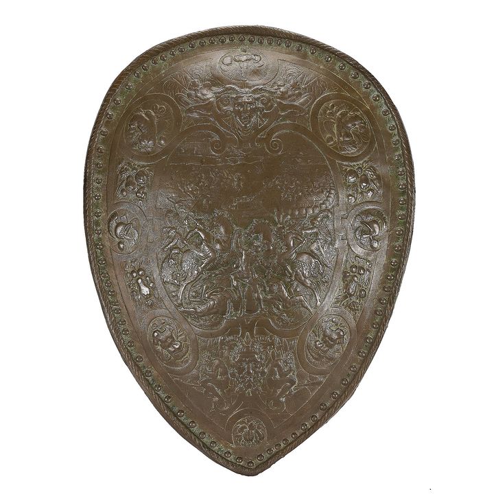 A bronzed plaster decorative shield in the style of Elkington & Co.