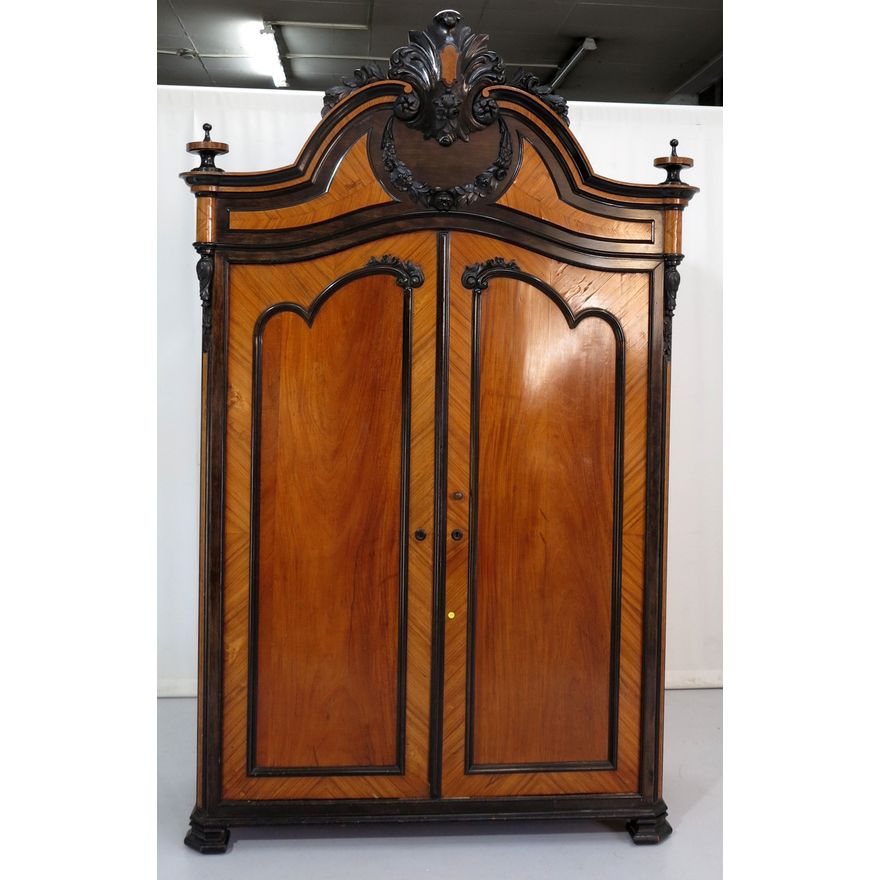 DUTCH CARVED AND EBONIZED MAHOGANY ARMOIRE