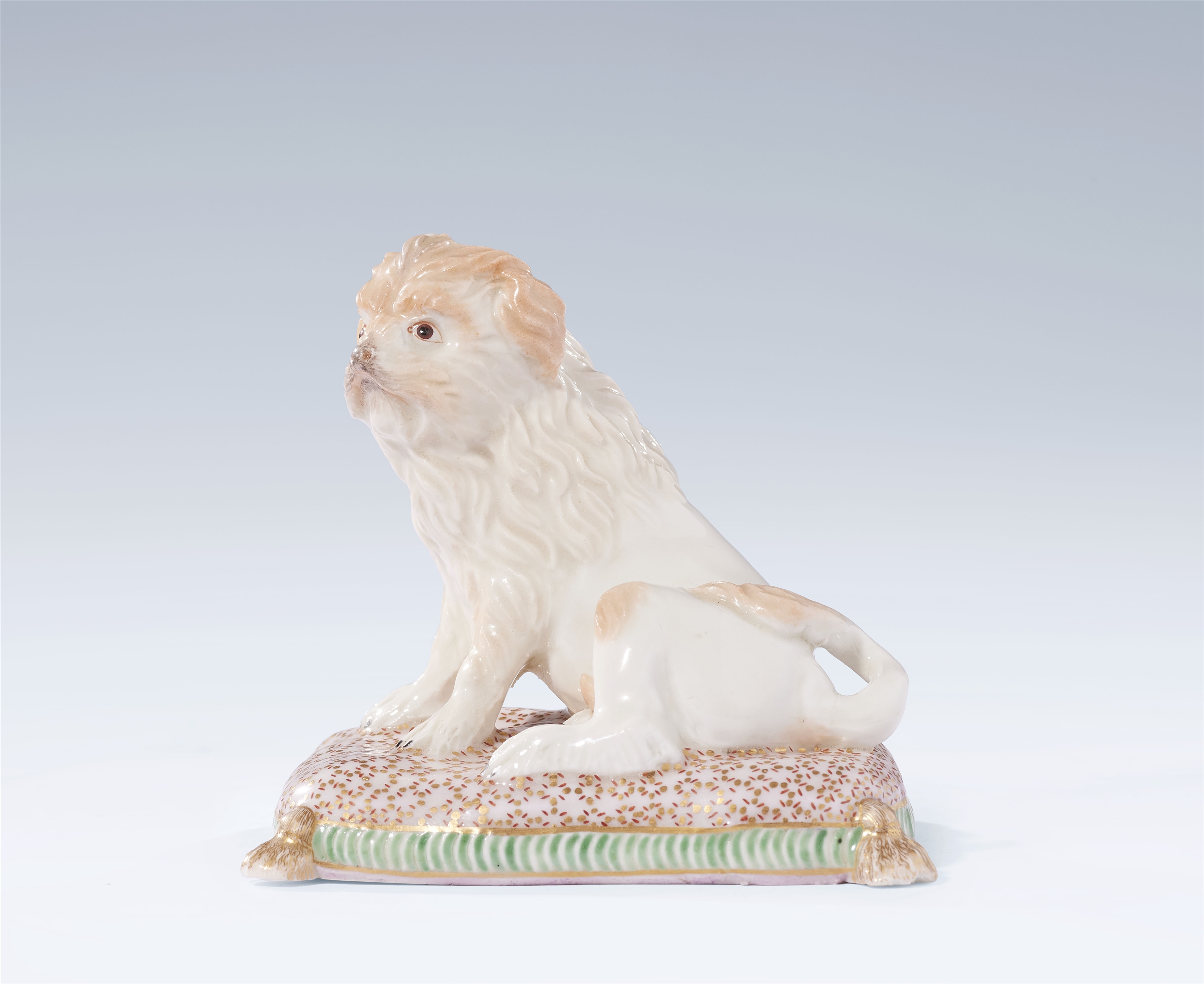 A Ludwigsburg porcelain dog on a cushion by Jean-Jacques Louis
