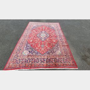 A VIBRANT PERSIAN MASHAD FLOOR RUG, with central medallion surrounded by dense intertwined floral and foliage