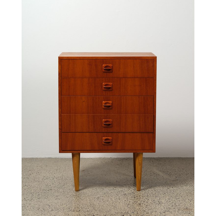 A five-drawer teak cabinet