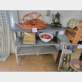 Short metal shelving unit and balance of items on it