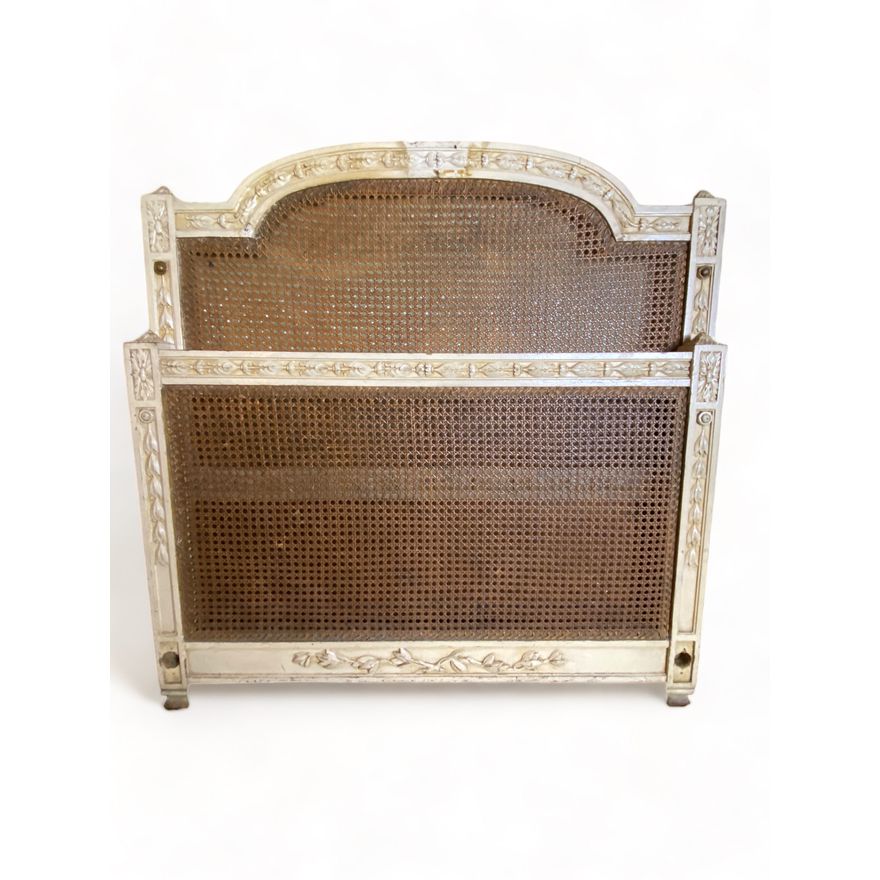 An early 20th century Louis XVI style white painted and caned single bed