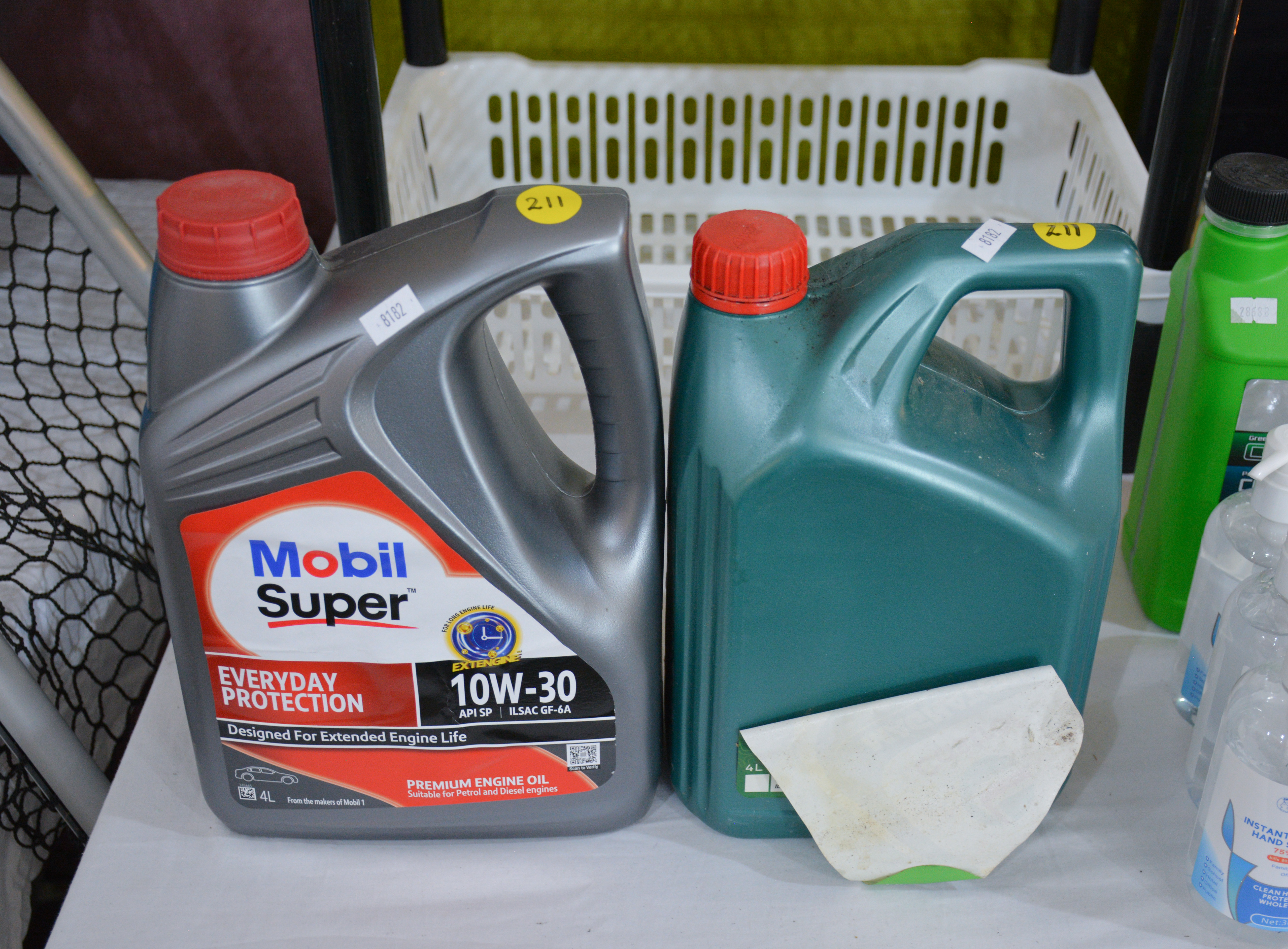 Mobil Engine Oil and Castrol Magnatec 5W-30 — sold at auction in New Zealand for $15