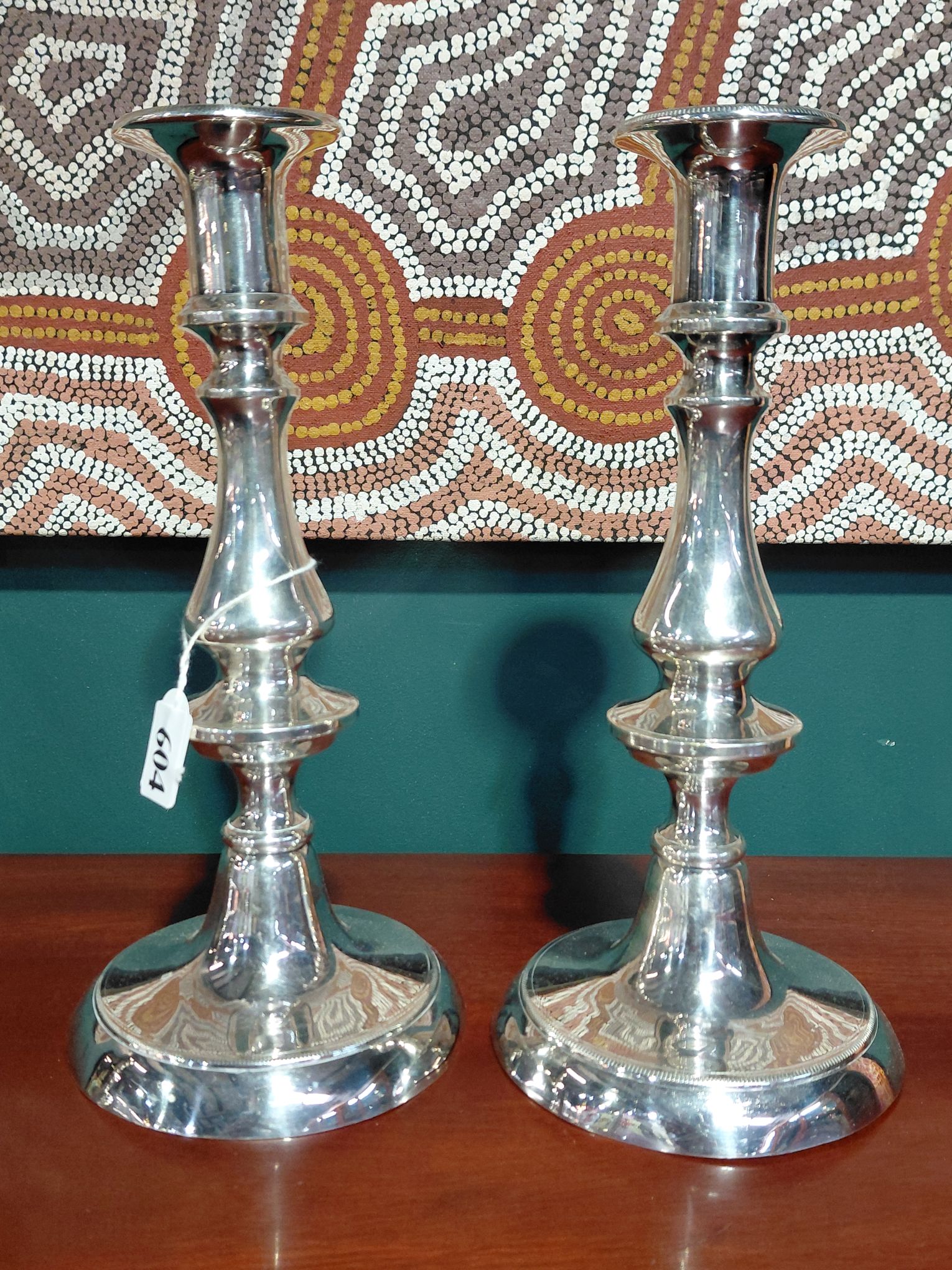 A PAIR OF SILVERPLATED CANDLESTICKS