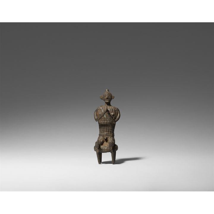 A copper alloy figure of a seated man. Central India, Orissa/Andhra Pradesh border region, Maliah-Kondh tribe. Late 19th/20th century