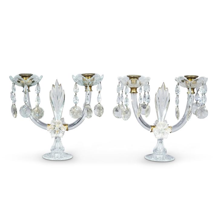 A pair of George IV cut-glass lustre twin-light candelabra
