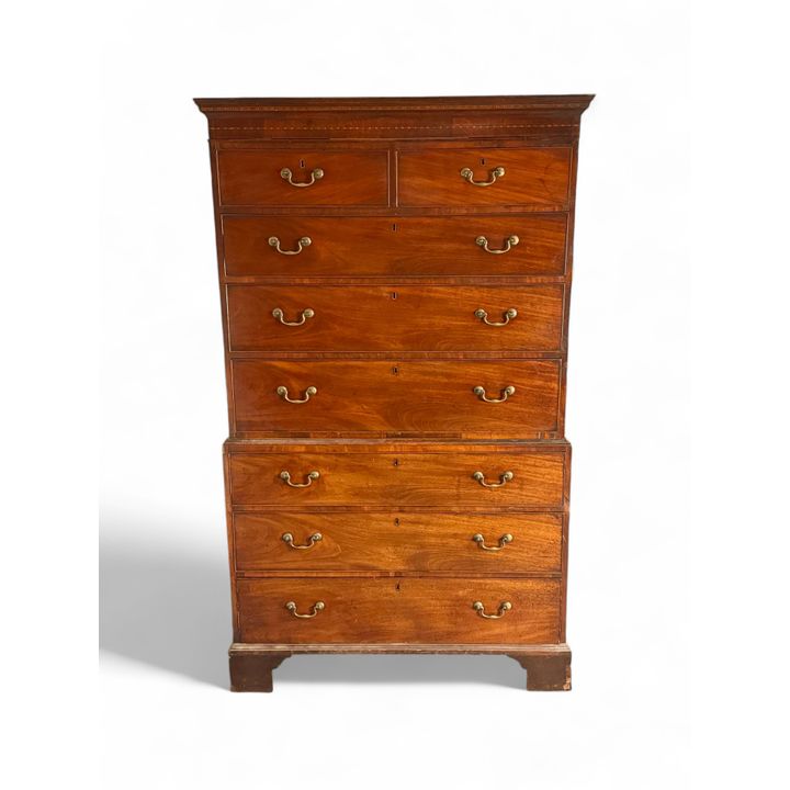 A George III mahogany and chequerbanded chest of chest with secret drawers
