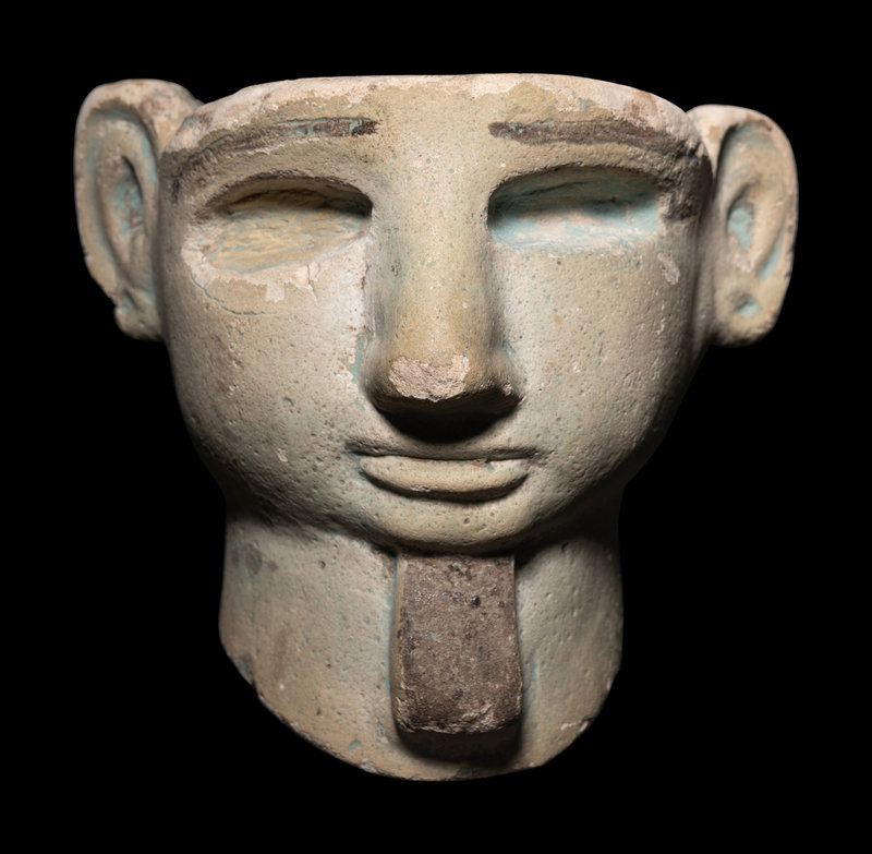 A Phoenician Faience Head 
Height 4 inches (10.16 cm).