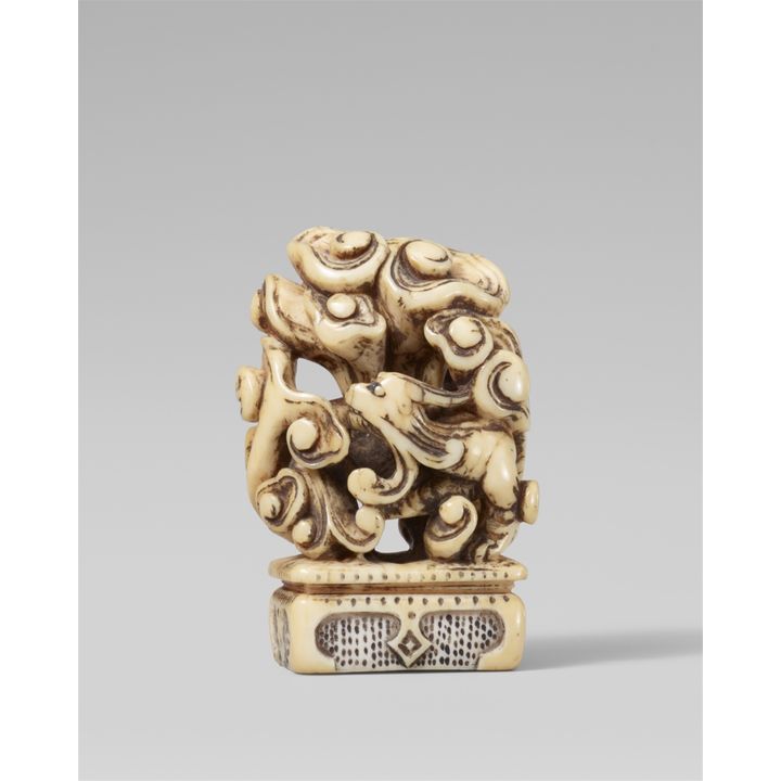An ivory seal-type netsuke of a mythological animal. 18th century