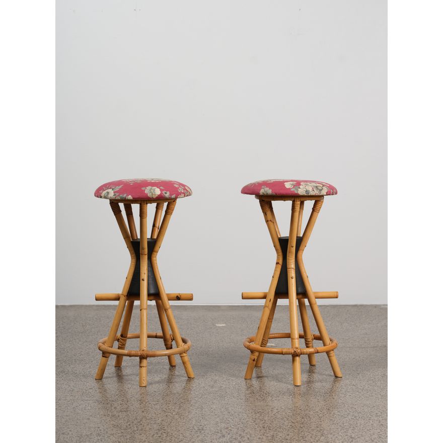 A pair of retro ‘Hawaiian’ bar stools - in nice condition, of hourglass form with fivepoint cane bases and floral upholstery to seat pads