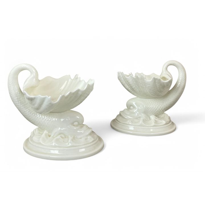 A pair of early 20th century Royal Worcester dolphin and shell salts or dishes