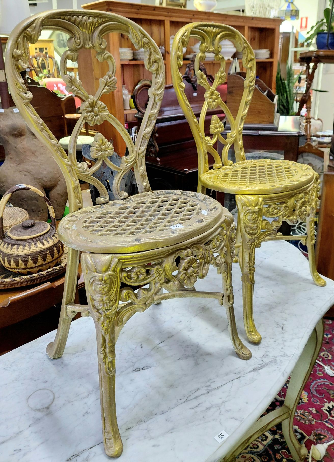 A Pair Of Cast Iron Chairs