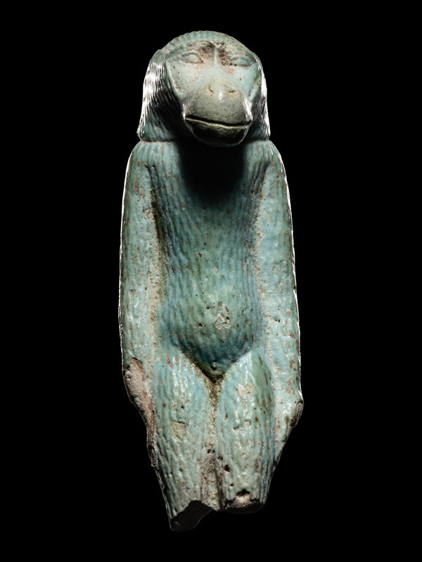 An Egyptian Faience Standing Ape
Height 2 1/2 inches (6.35 cm).