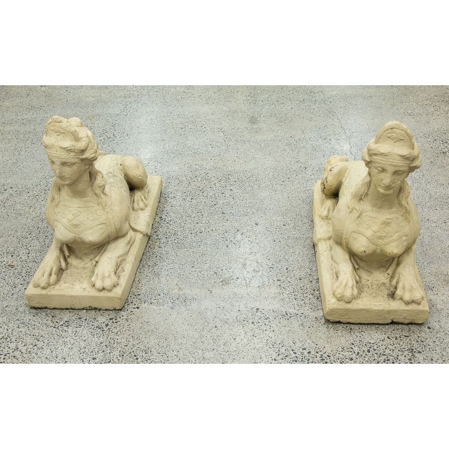 A large and heavy pair of composite stone sphinx