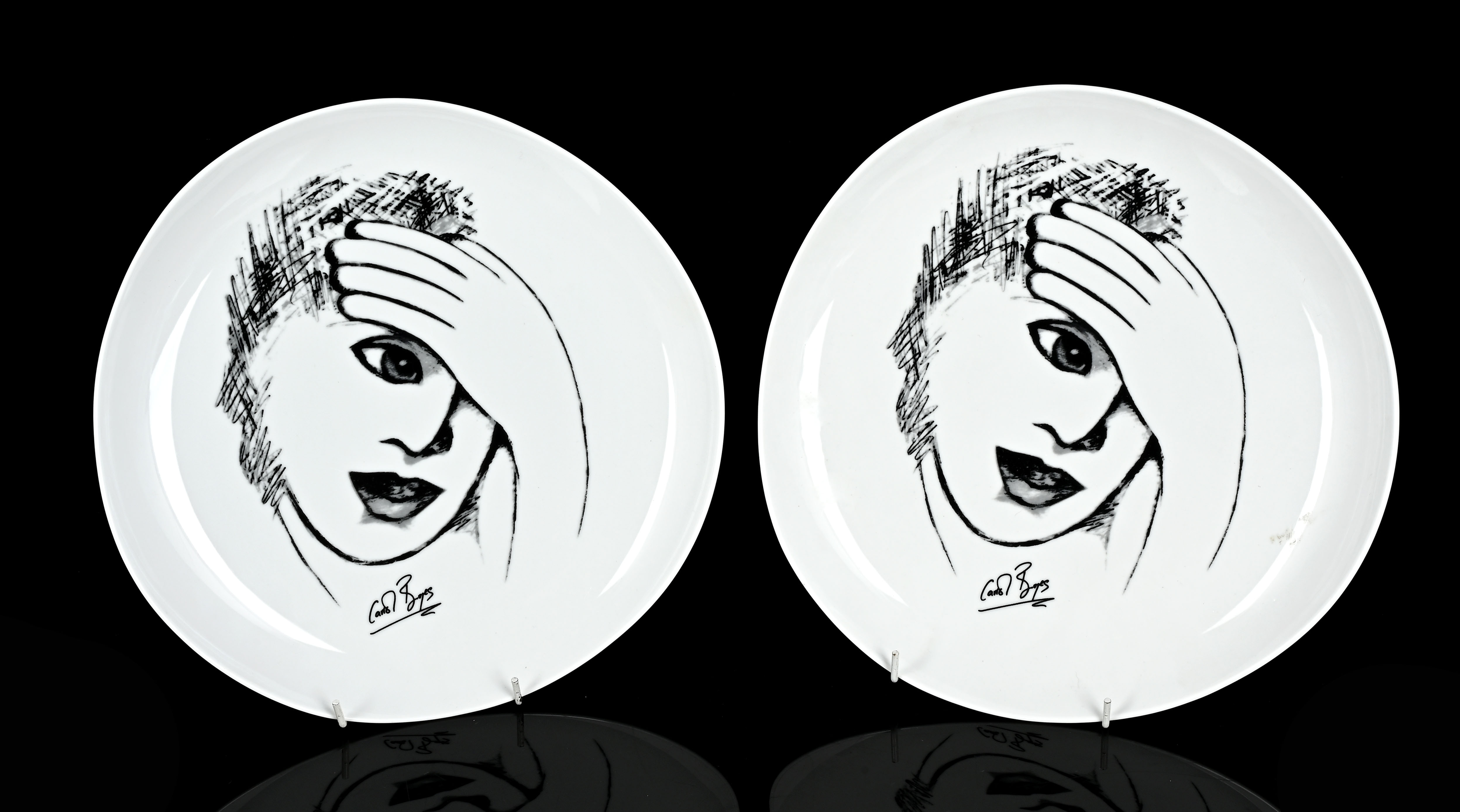 Two Carrol Boyes 'Sketchbook' series dinner plates, a black line
