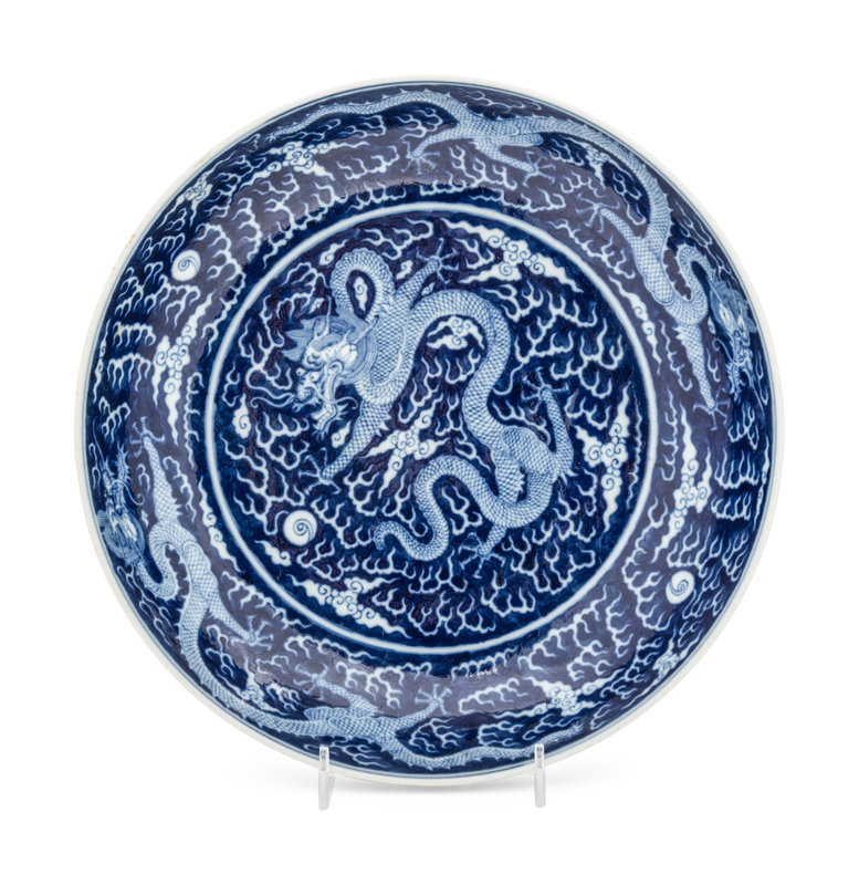 A Reverse-Decorated Blue and White Porcelain 'Dragon' Plate
Diameter 10 3/4 in., 27.3 cm.