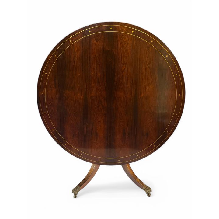 A 19th century rosewood and brass inlaid breakfast table in the Regency style