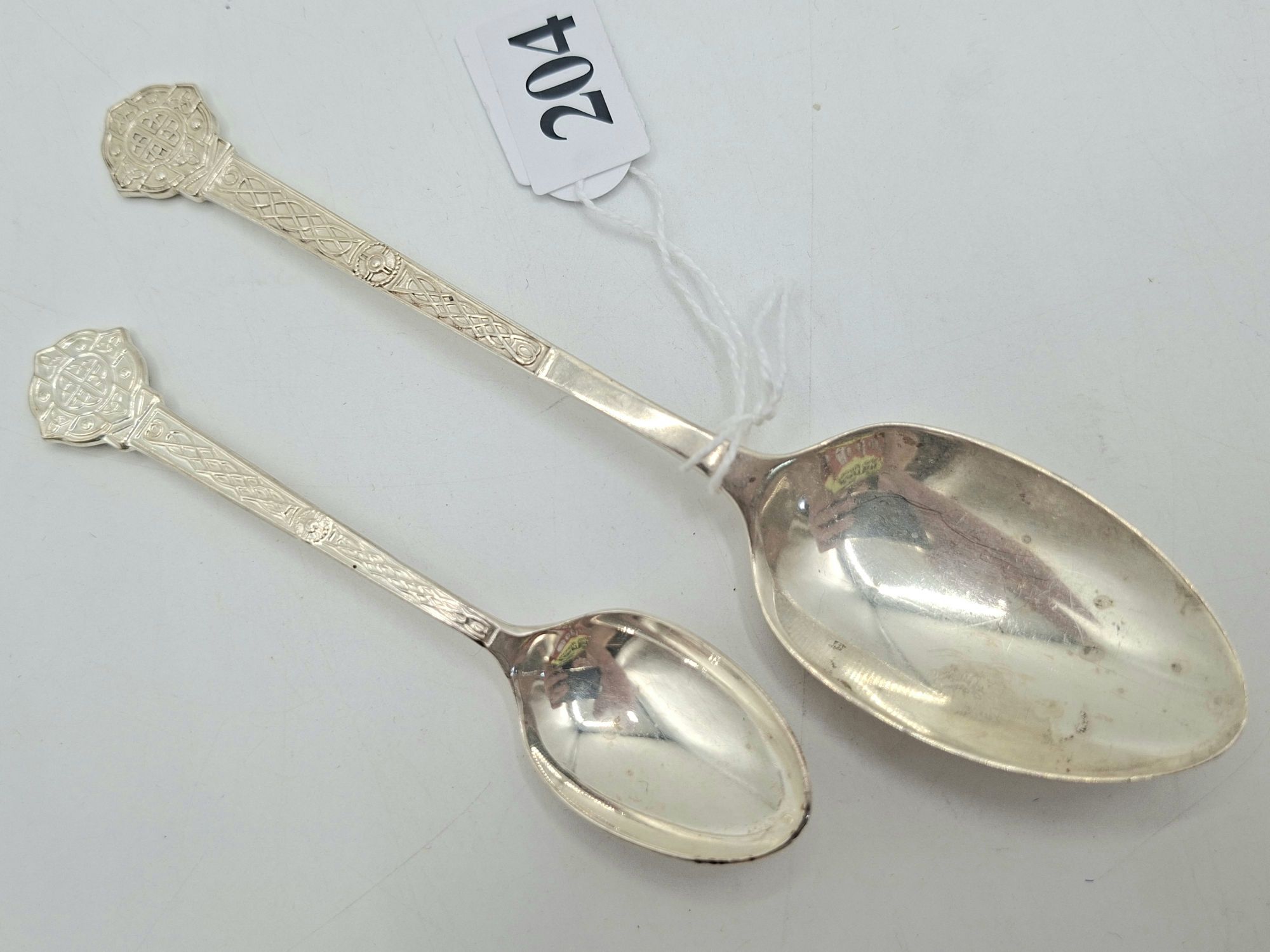 204 · TWO STERLING SILVER SERVING SPOONS
