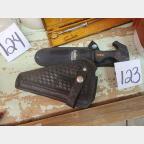 Leather pistol holder and Camillus small tree saw