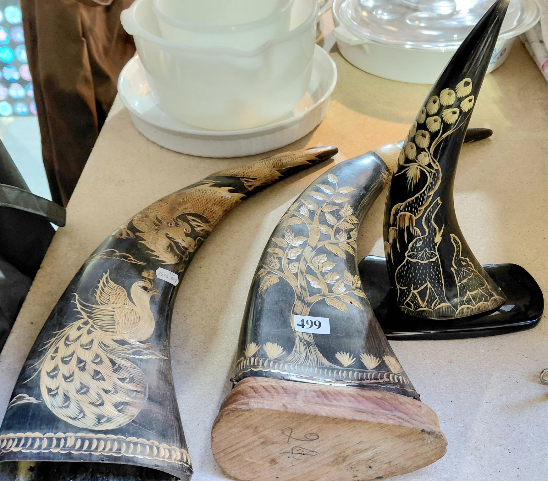 THREE CARVED HORN ORNAMENTS