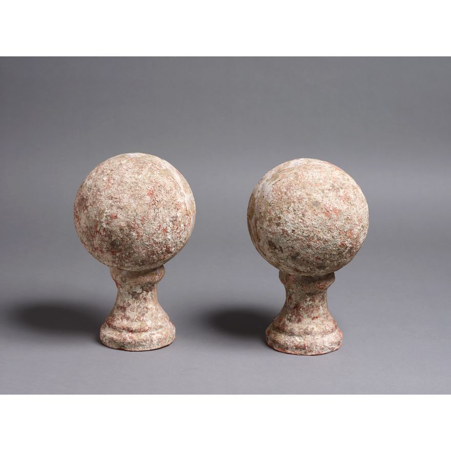 A pair of decorative earthenware orbs