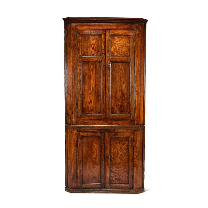 A George III elm and oak floor standing corner cupboard