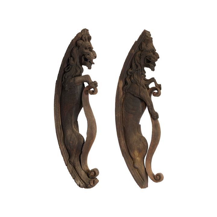 A pair of 18th century architectural carved oak lion corbels of scrolling form