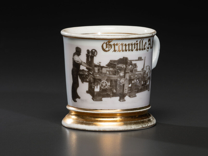 A Photographic Transfer Shaving Mug Depicting a Printer at his Press