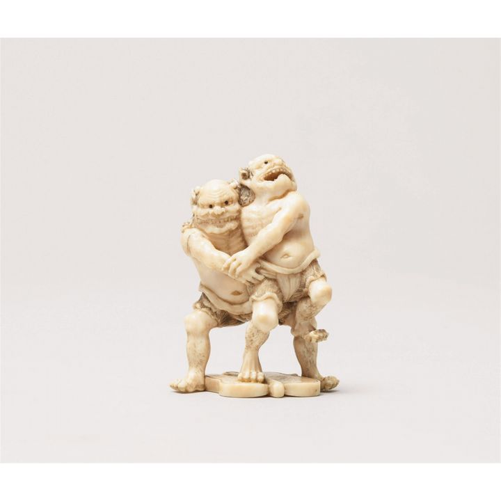 A fine ivory netsuke of two wrestling oni. Late 19th century