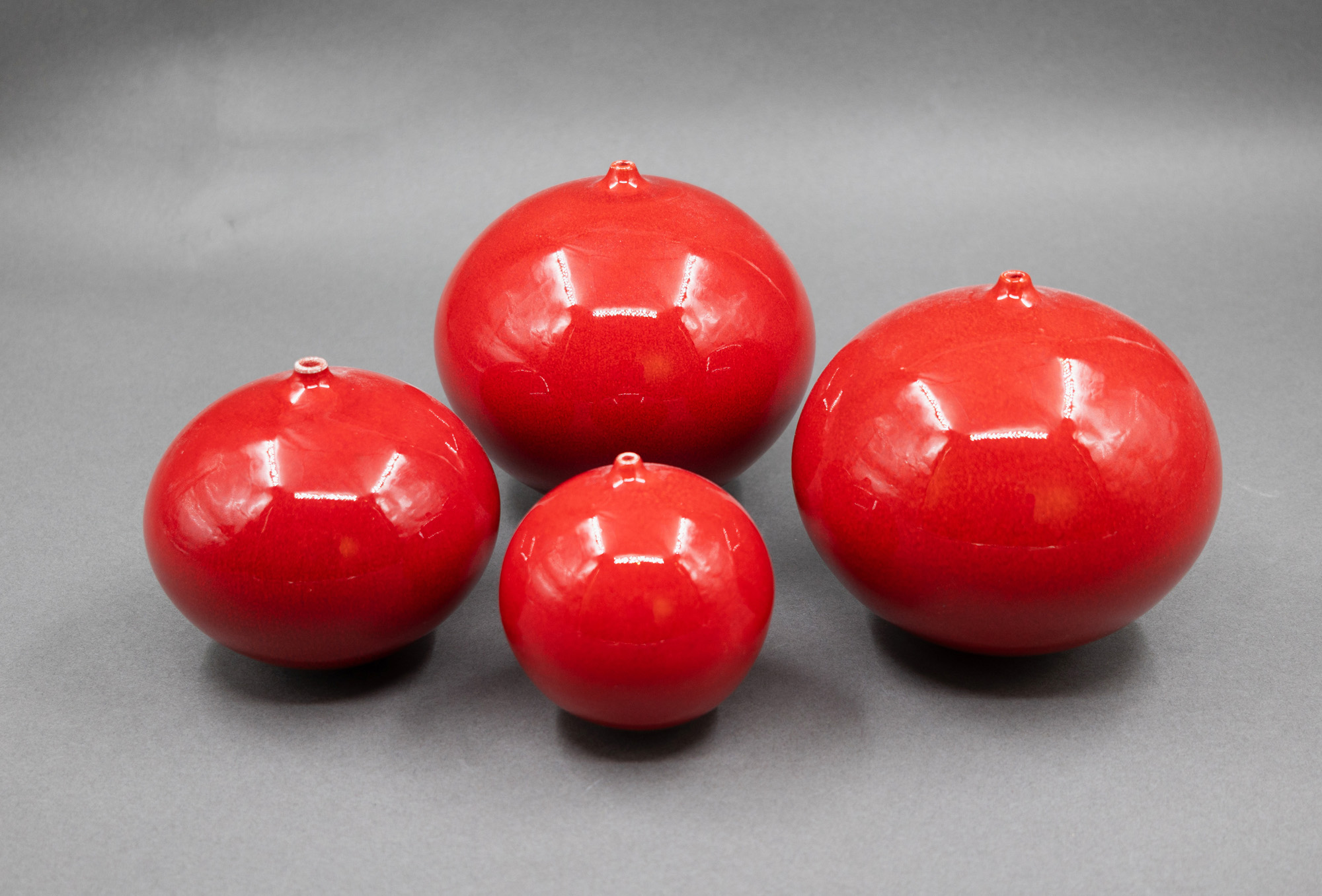 Graham Ambrose - Four small red orb vases — sold at auction in New Zealand for $950