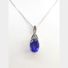 8.143CT OVAL TANZANITE WITH 0.15CT DIAMONDS IN A WHITE GOLD PENDANT WITH A 9CT WHITE GOLD CHAIN
