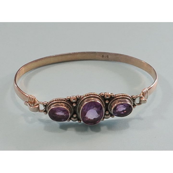 A STERLING SILVER AND AMETHYST BANGLE.
