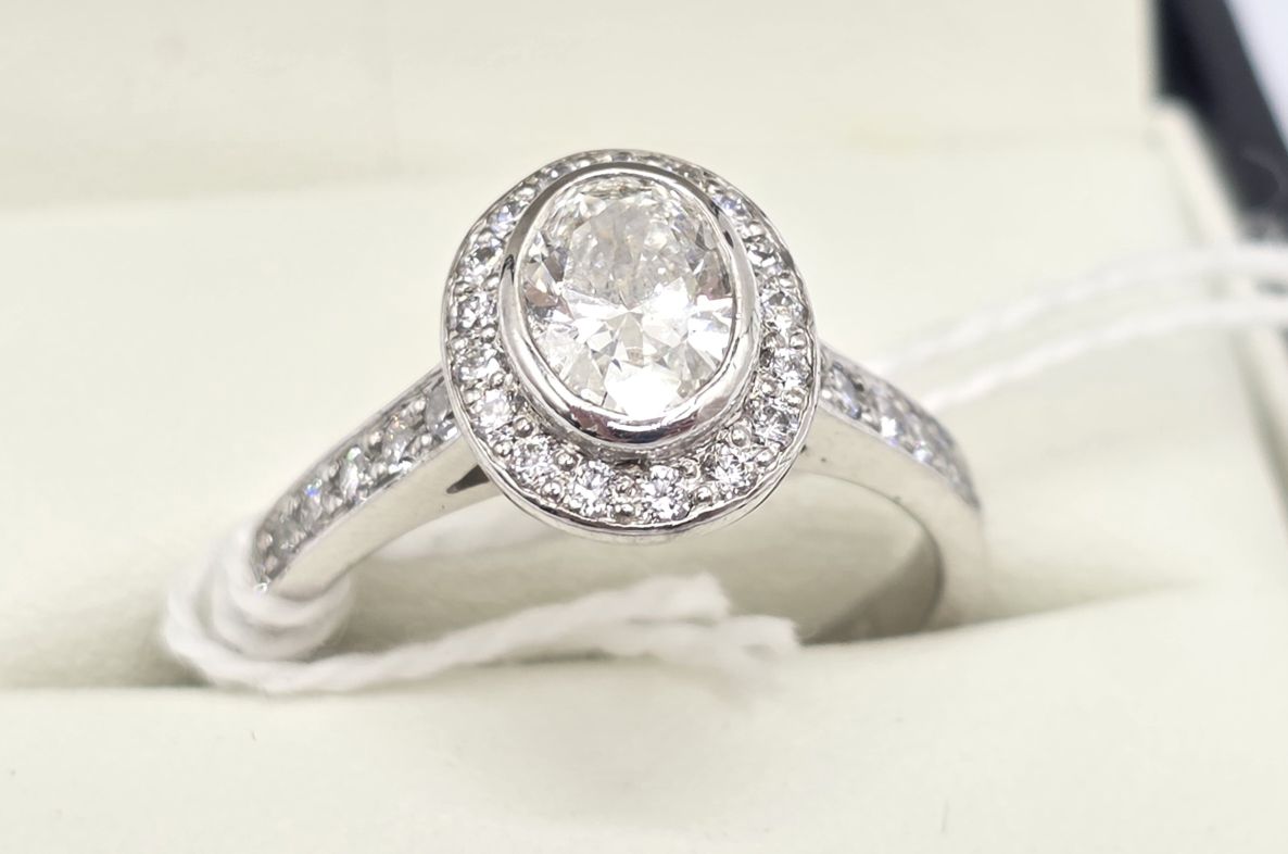 132 · 18CT WHITE GOLD DIAMOND HALO RING