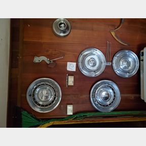 Chrome hubcaps, rim and smoking stand on south wall