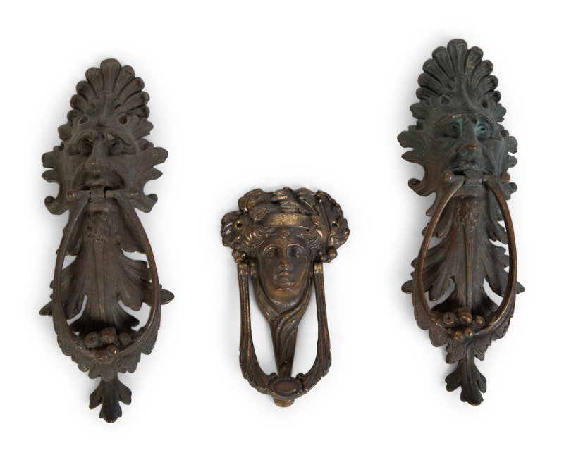 A Group of Three Continental Patinated Metal Door Knockers
Height of pair 8 1/2 inches.