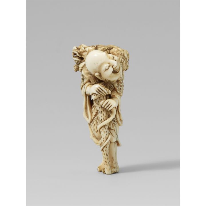 An ivory netsuke of a laughing sennin with a shishi. Early 19th century