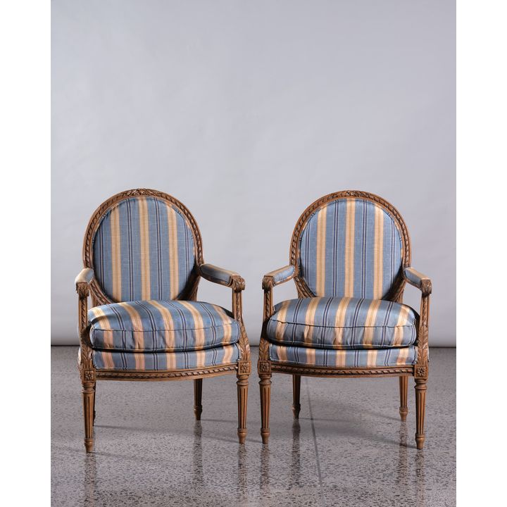 A pair of French carved armchairs