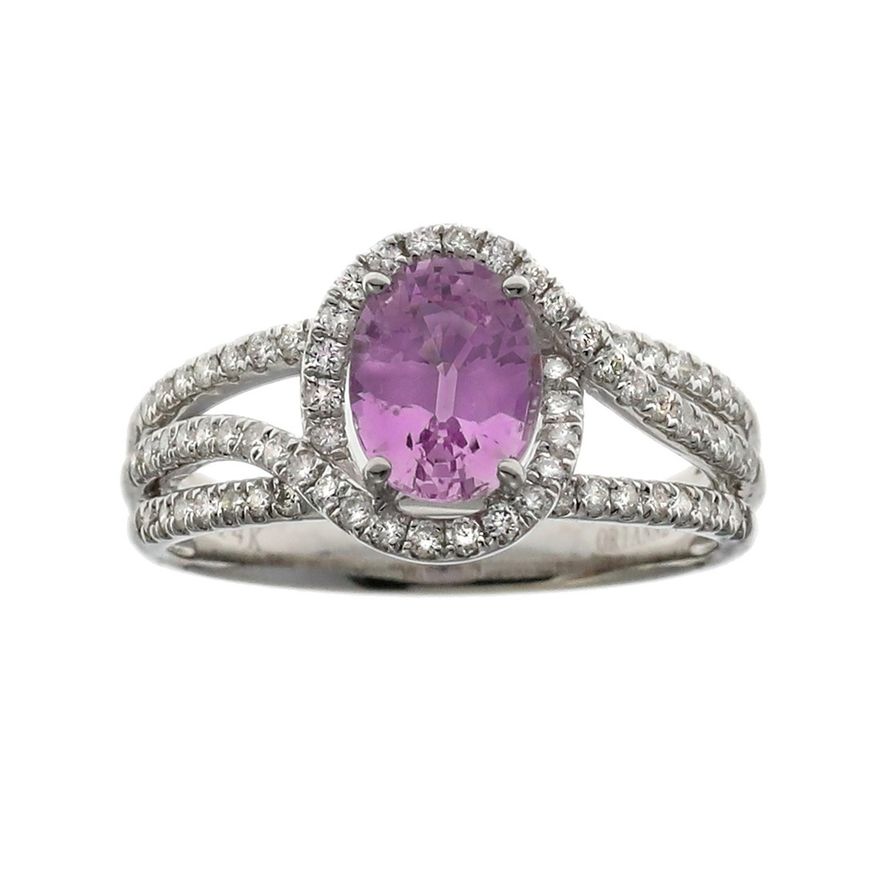 A Pink Sapphire and Diamond Ring The oval cut pink sapphire weighing 1. ...