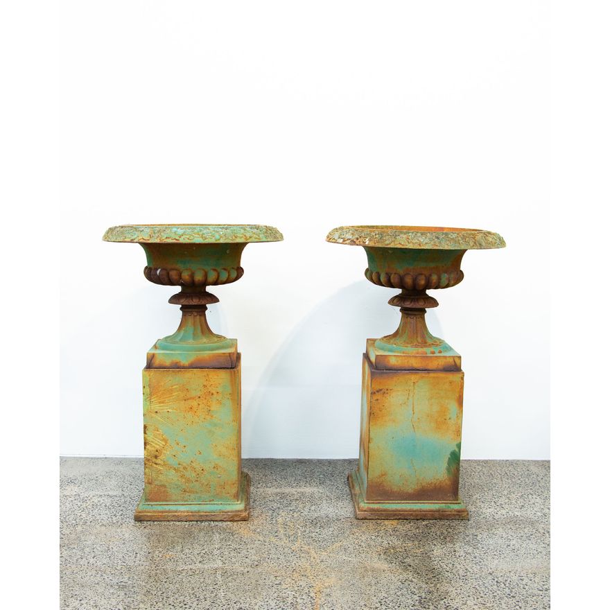 A pair of cast iron urns