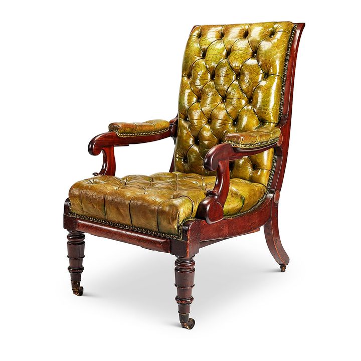 A George IV mahogany green leather patent reclining library armchair by Daws