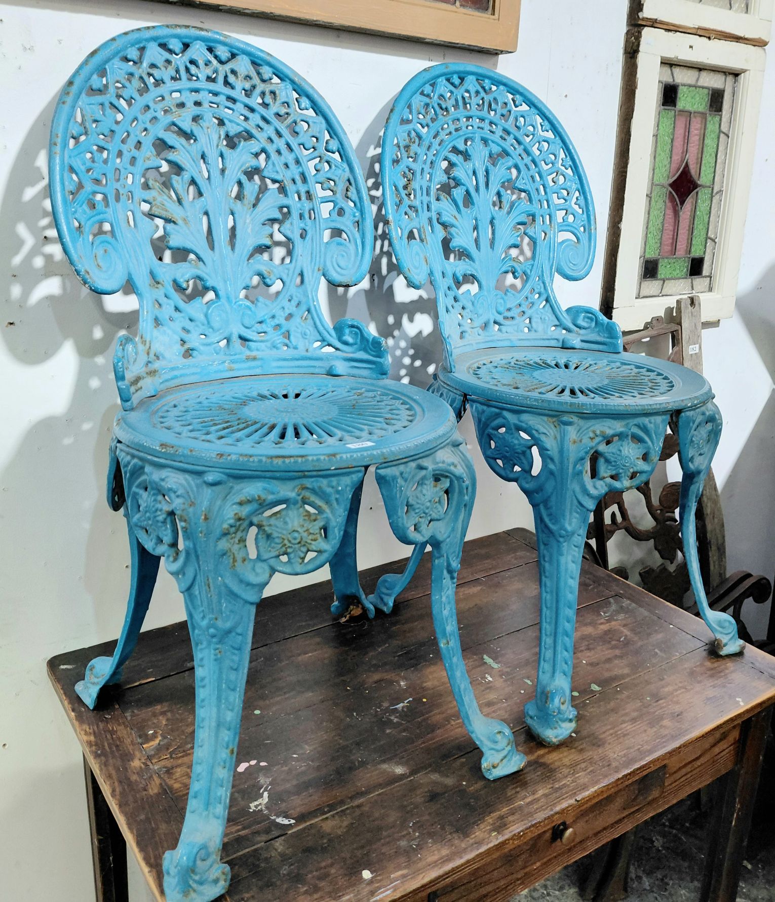 180 · A PAIR OF CAST IRON CHAIRS